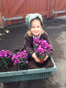Miss Kaylah helping me plant some September asters in memory of the little unborn one we lost two years ago. 